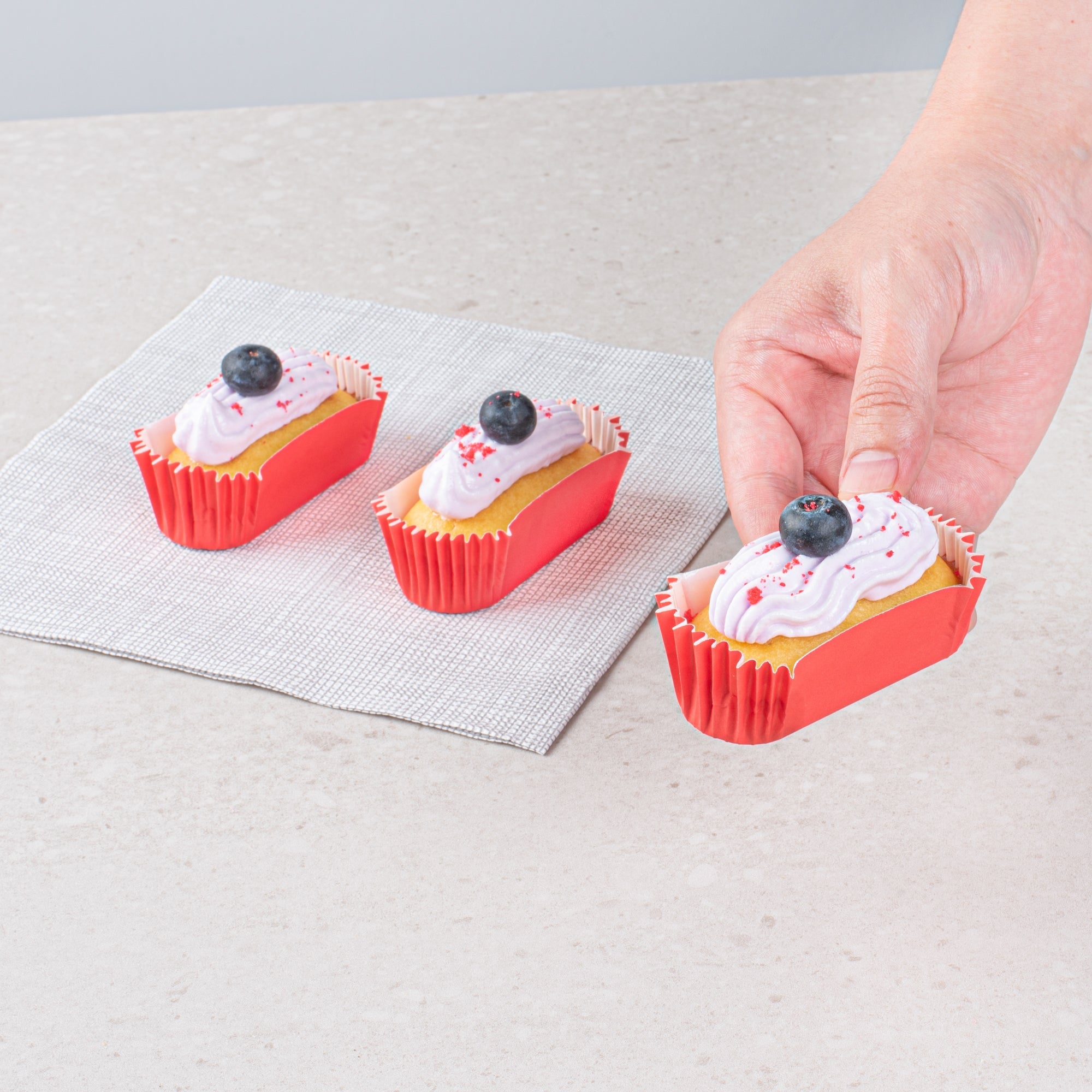 Panificio 1 oz Elliptical Red Paper Regular Baking Cup - Ridged - 3 1/2" x 1 1/2" x 3/4" - 200 count box