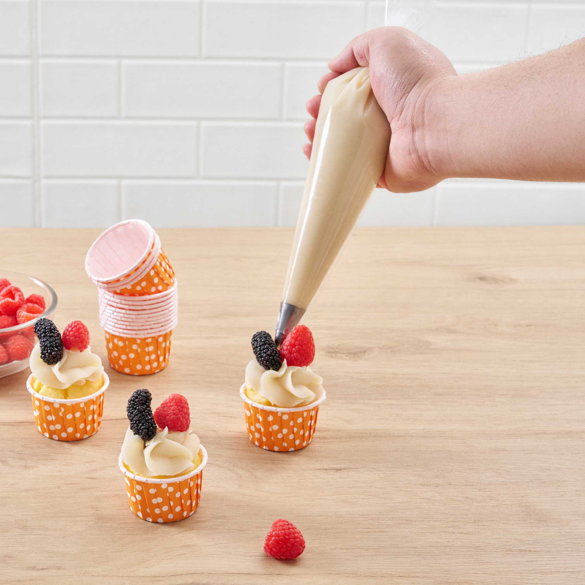 Panificio 2 oz Round Polka-Dotted Hot Orange Paper Medium Baking Cup - Pleated - 2 1/4" x 2 1/4" x 1 1/2" - 200 count box