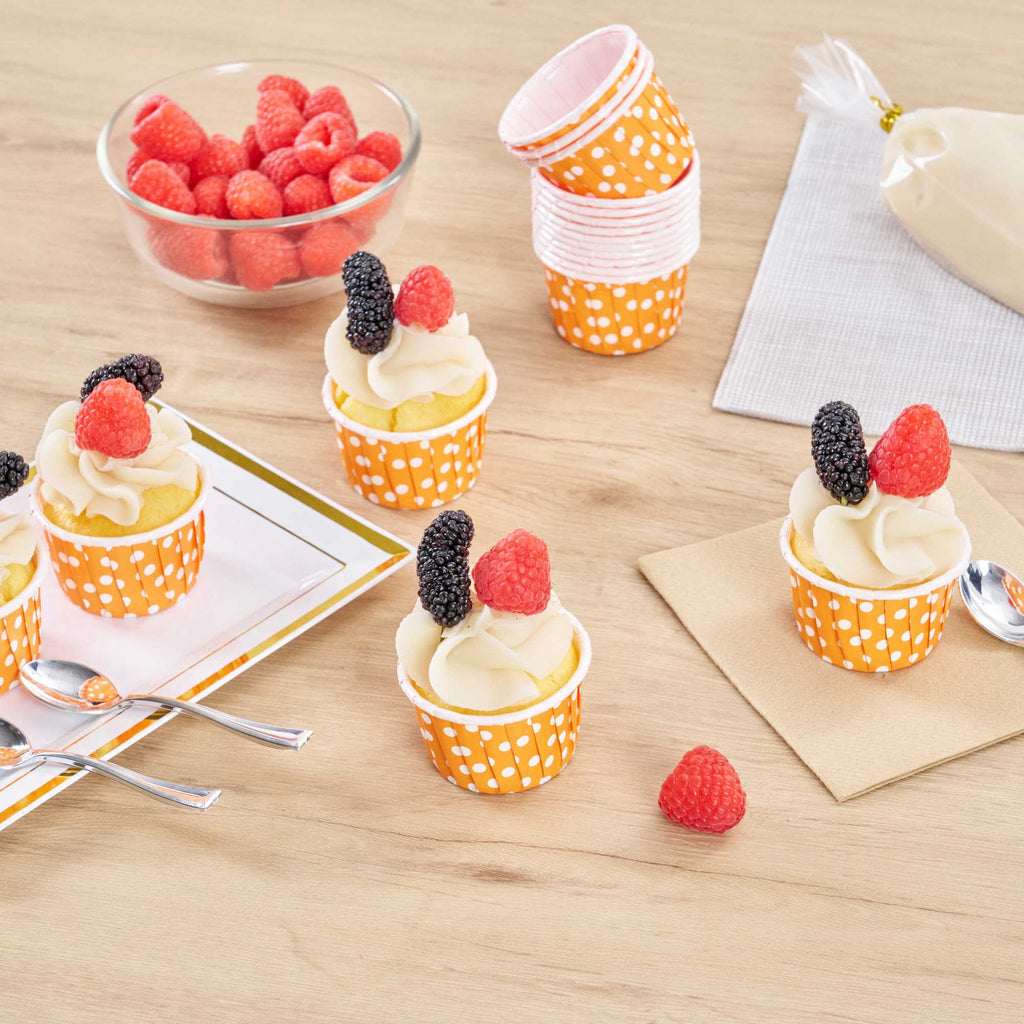 Panificio 2 oz Round Polka-Dotted Hot Orange Paper Medium Baking Cup - Pleated - 2 1/4" x 2 1/4" x 1 1/2" - 200 count box