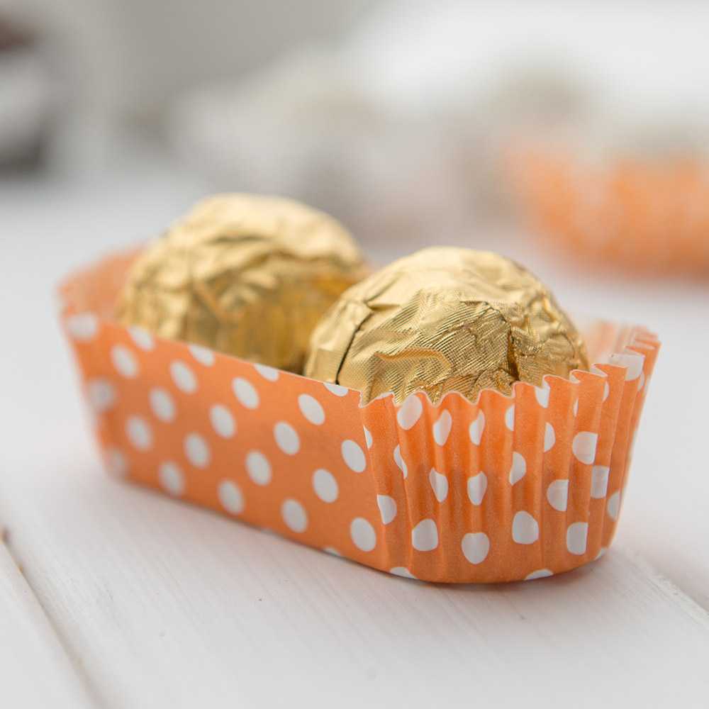 Panificio 1 oz Elliptical Polka-Dotted Hot Orange Paper Regular Baking Cup - Ridged - 3 1/2" x 1 1/2" x 3/4" - 200 count box