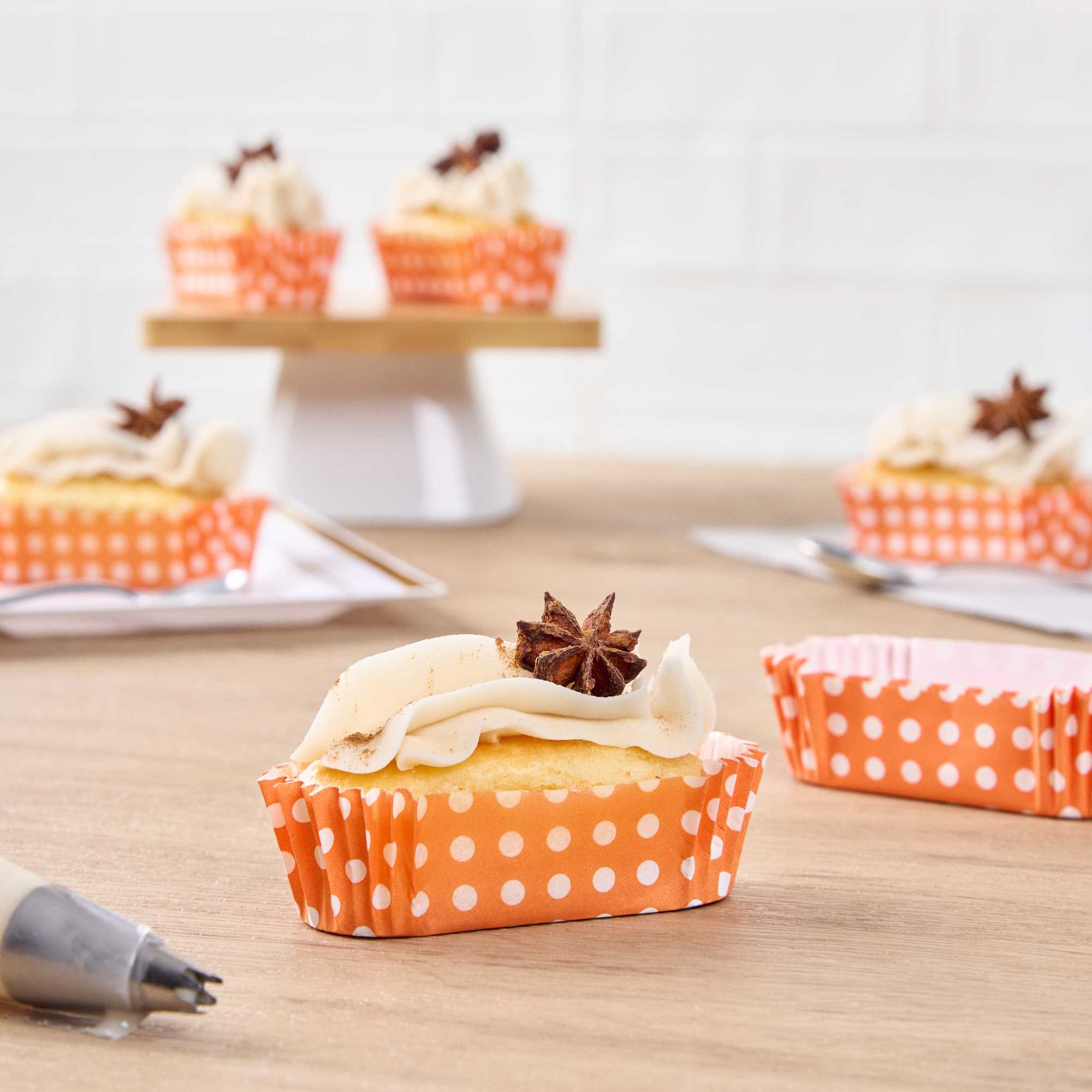 Panificio 1 oz Elliptical Polka-Dotted Hot Orange Paper Regular Baking Cup - Ridged - 3 1/2" x 1 1/2" x 3/4" - 200 count box