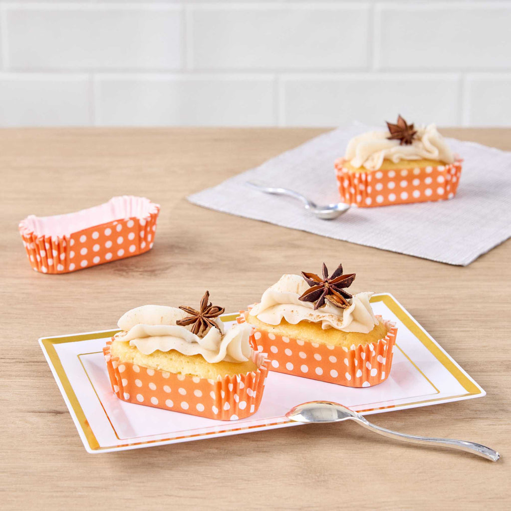 Panificio 1 oz Elliptical Polka-Dotted Hot Orange Paper Regular Baking Cup - Ridged - 3 1/2" x 1 1/2" x 3/4" - 200 count box