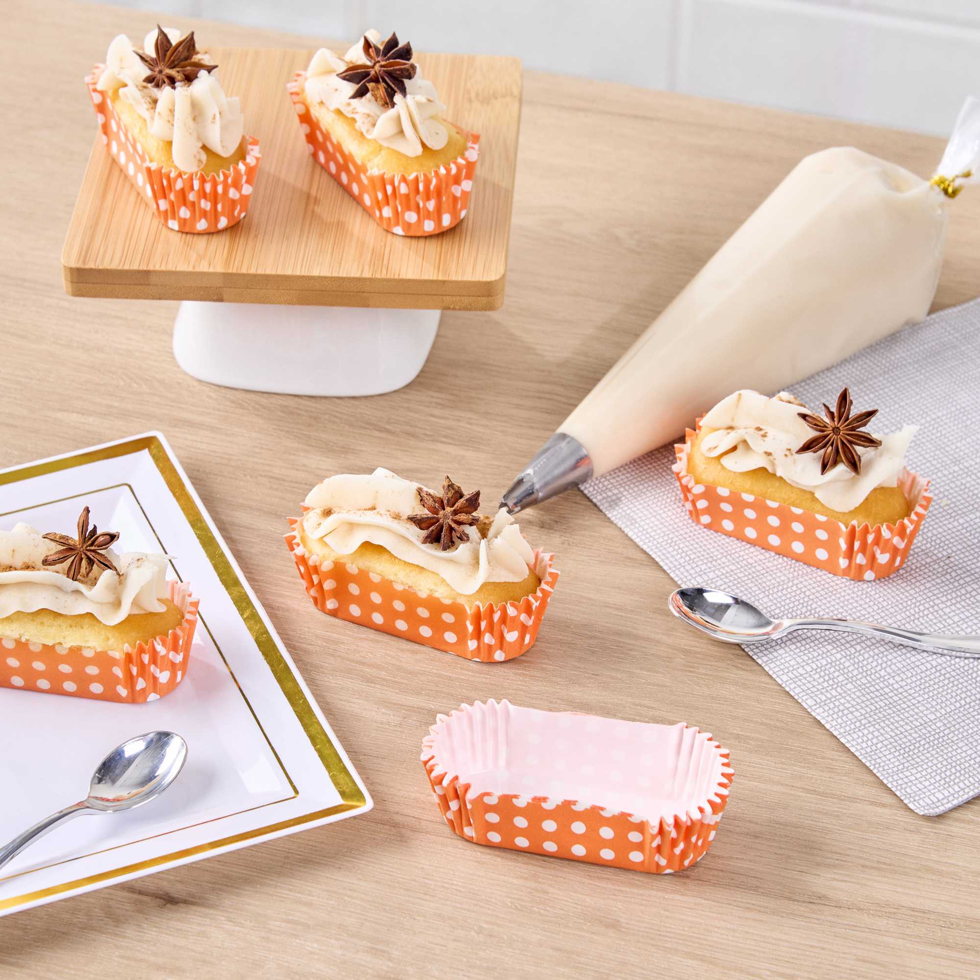 Panificio 1 oz Elliptical Polka-Dotted Hot Orange Paper Regular Baking Cup - Ridged - 3 1/2" x 1 1/2" x 3/4" - 200 count box