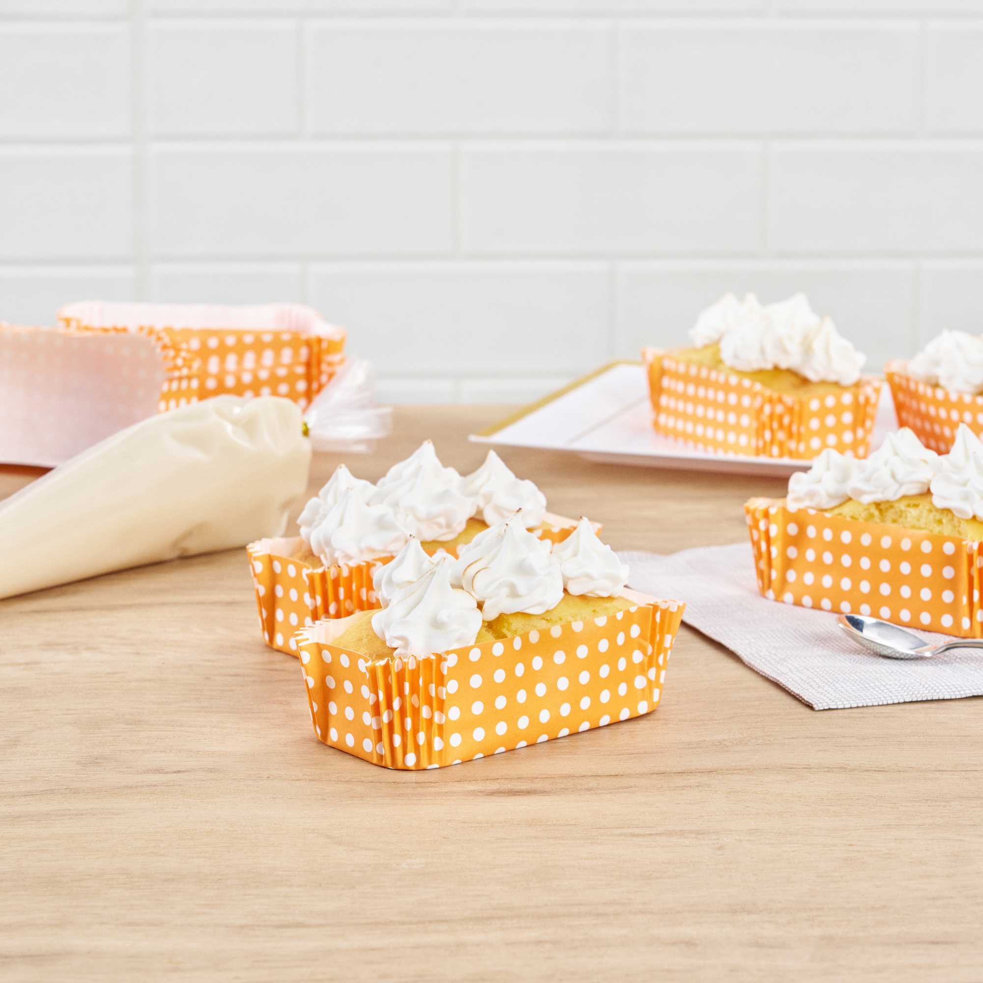 Panificio 5 oz Elliptical Polka-Dotted Hot Orange Paper Large Baking Cup - Ridged - 4 1/2" x 2 1/2" x 1 1/4" - 200 count box