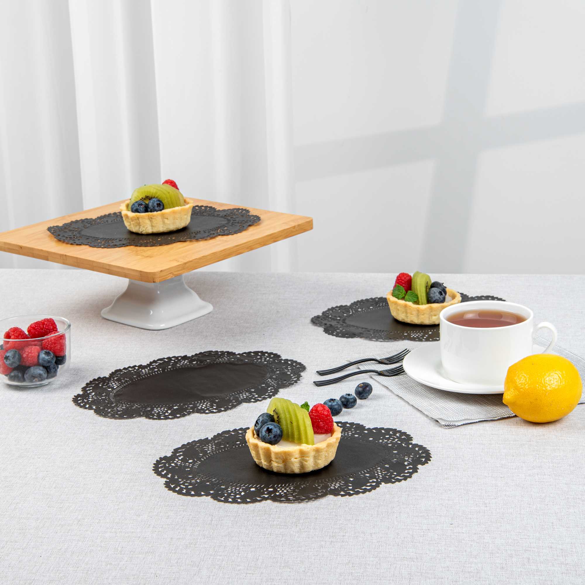 Pastry Tek Oval Black Paper Doilies - Lace - 9" x 6 1/2" - 100 count box