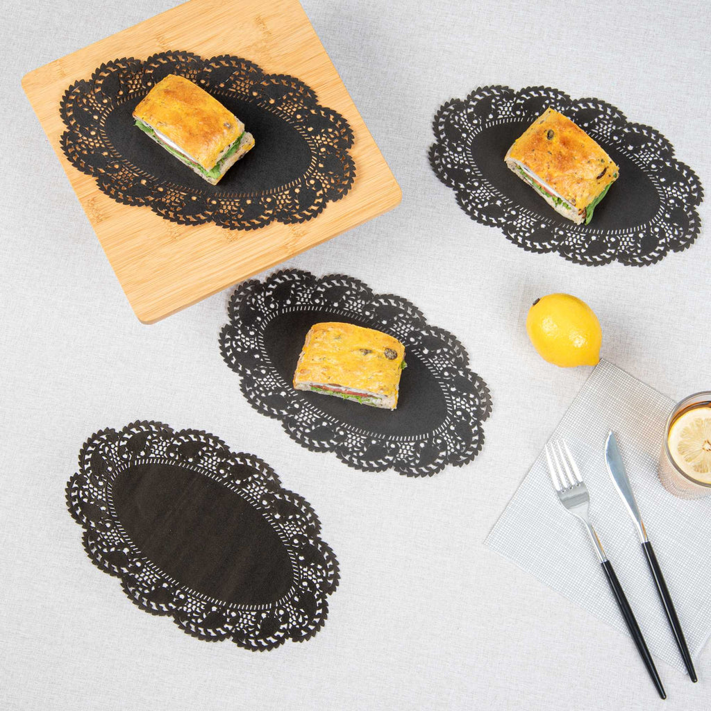 Pastry Tek Oval Black Paper Doilies - Lace - 10 1/2" x 6 1/2" - 100 count box