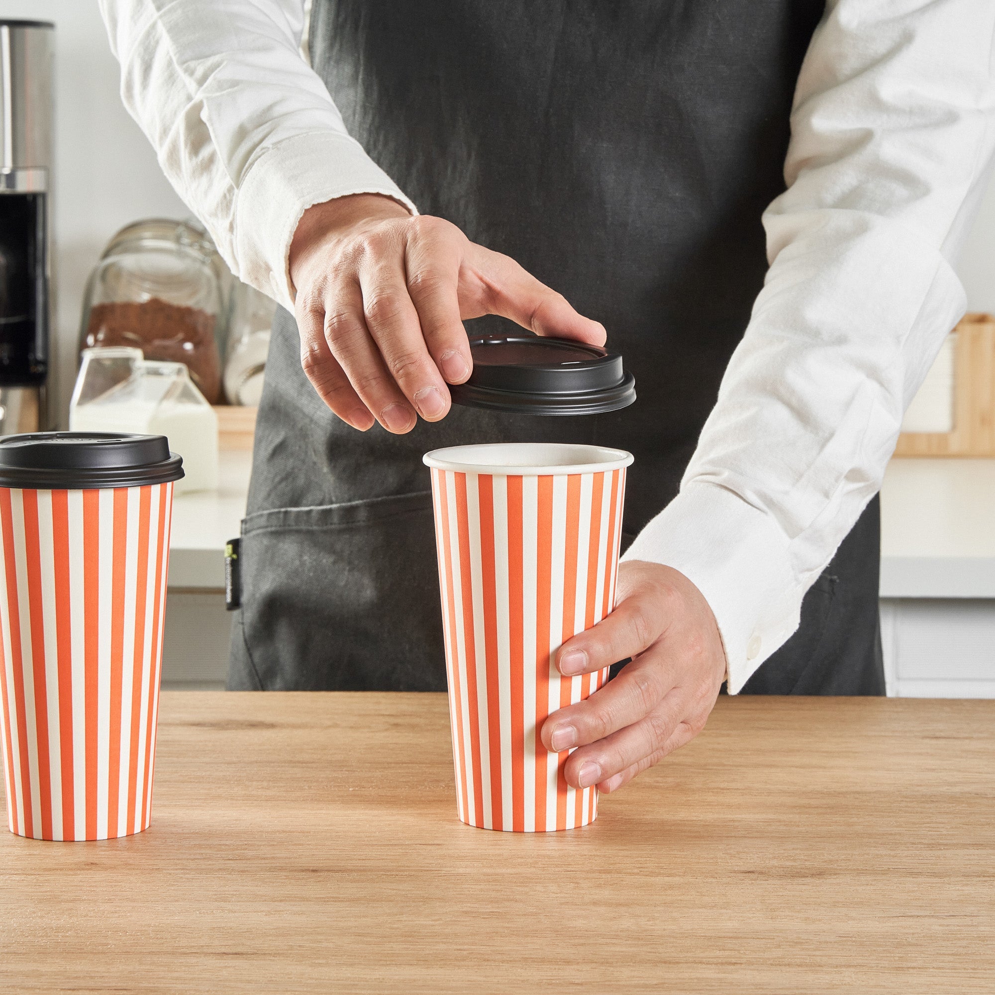 Restpresso 20 oz Orange and White Stripe Paper Single Wall Coffee Cup - with Black Lid - 3 1/2"x 3 1/2"x 6 1/4" - 400 count box