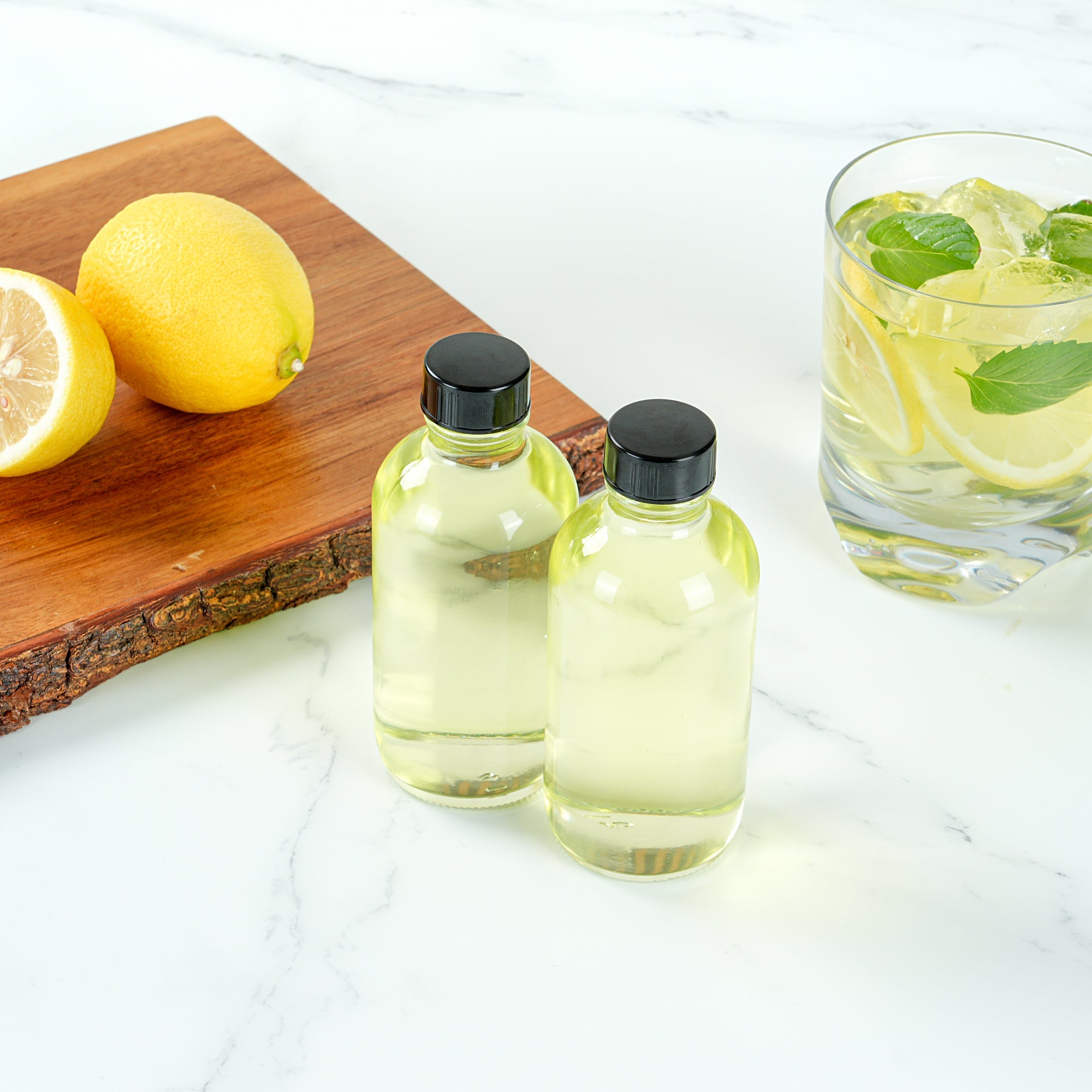 Vetri 4 oz Boston Round Clear Glass Bottle - with Black Phenolic Cap - 2" x 2" x 4 1/2" - 24 count box