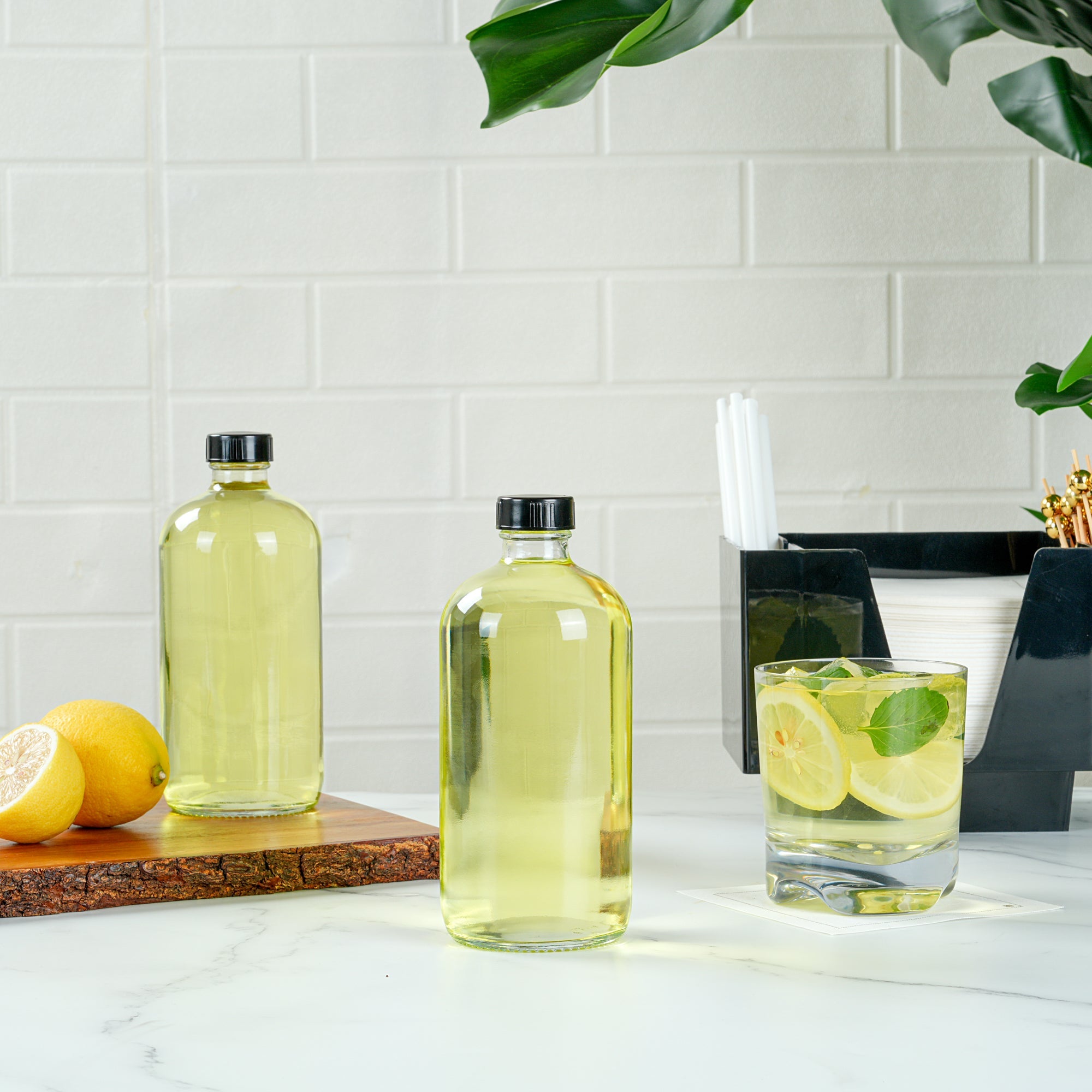 Vetri 16 oz Boston Round Clear Glass Bottle - with Black Phenolic Cap - 3" x 3" x 6 3/4" - 12 count box