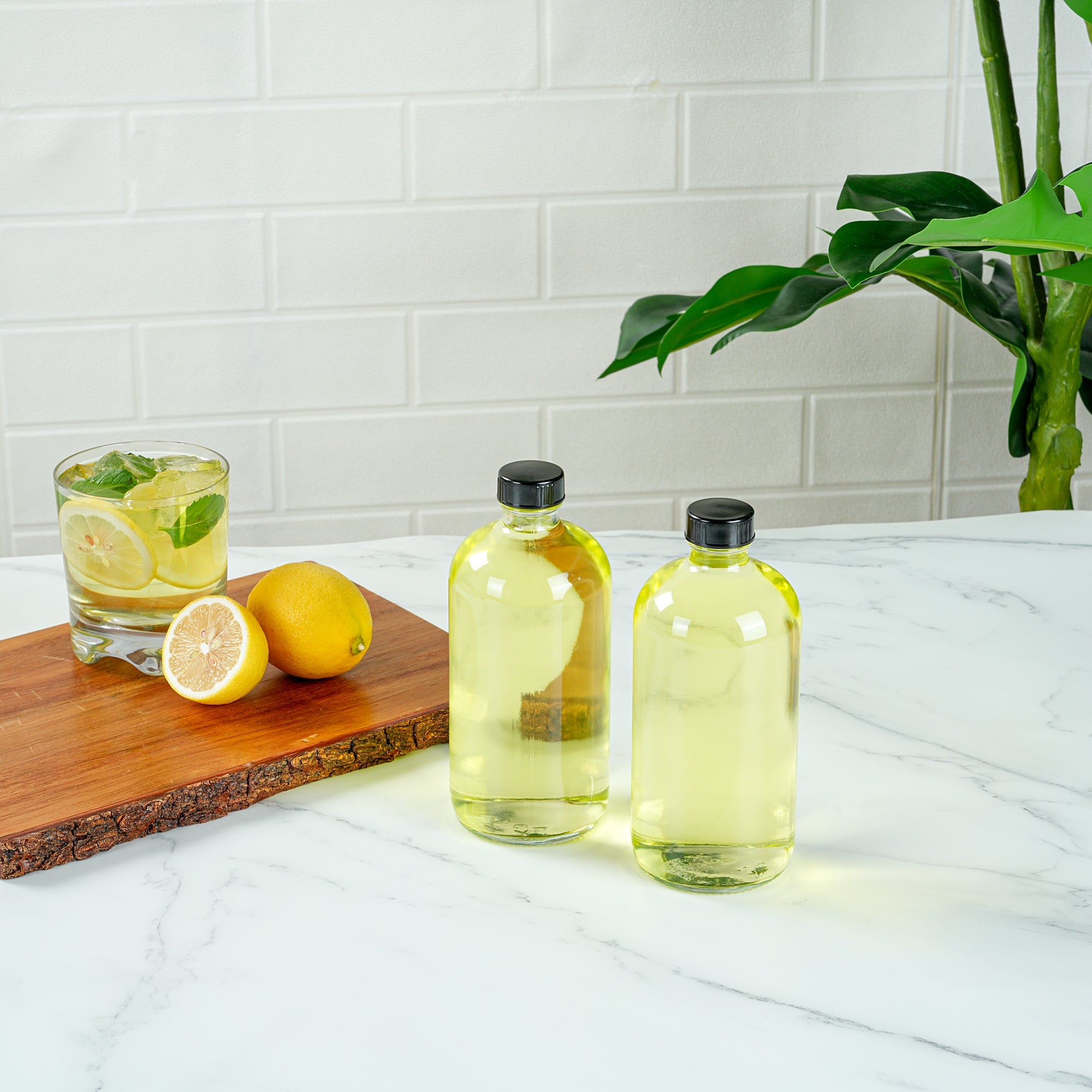 Vetri 16 oz Boston Round Clear Glass Bottle - with Black Phenolic Cap - 3" x 3" x 6 3/4" - 12 count box