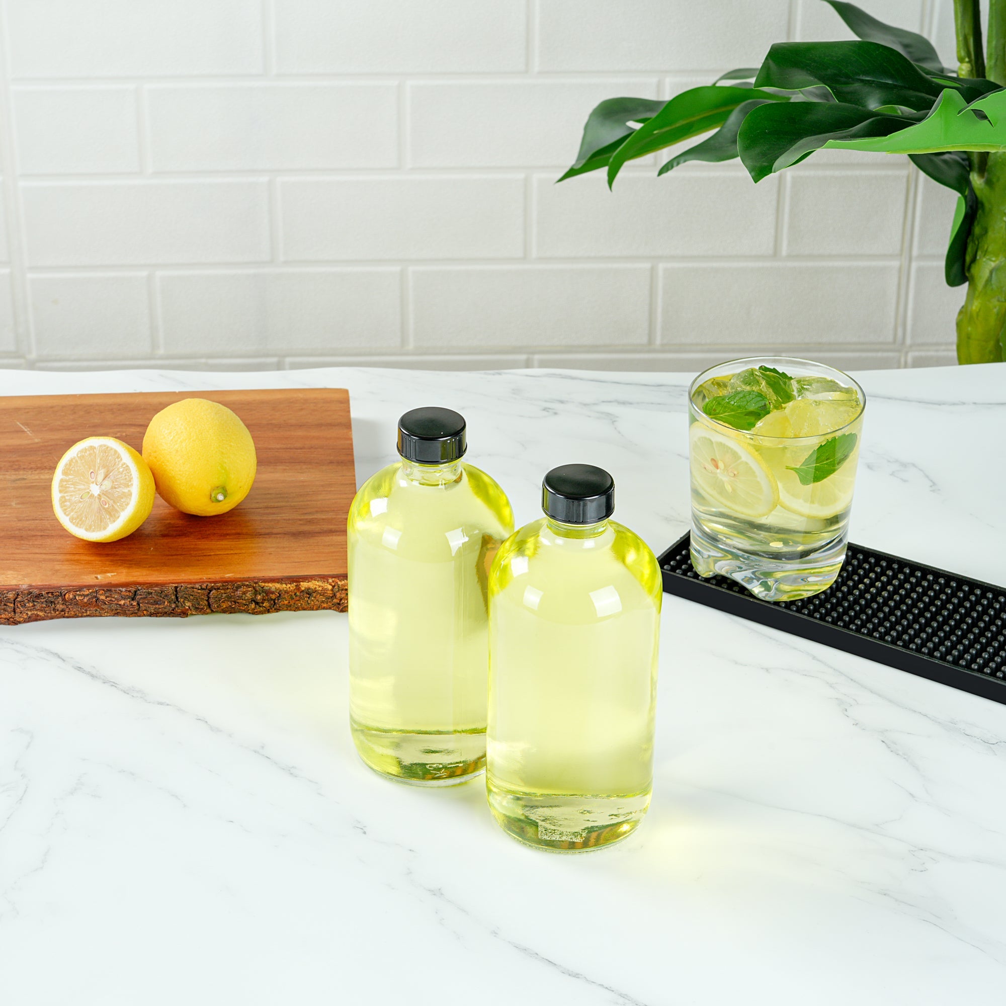 Vetri 16 oz Boston Round Clear Glass Bottle - with Black Phenolic Cap - 3" x 3" x 6 3/4" - 12 count box