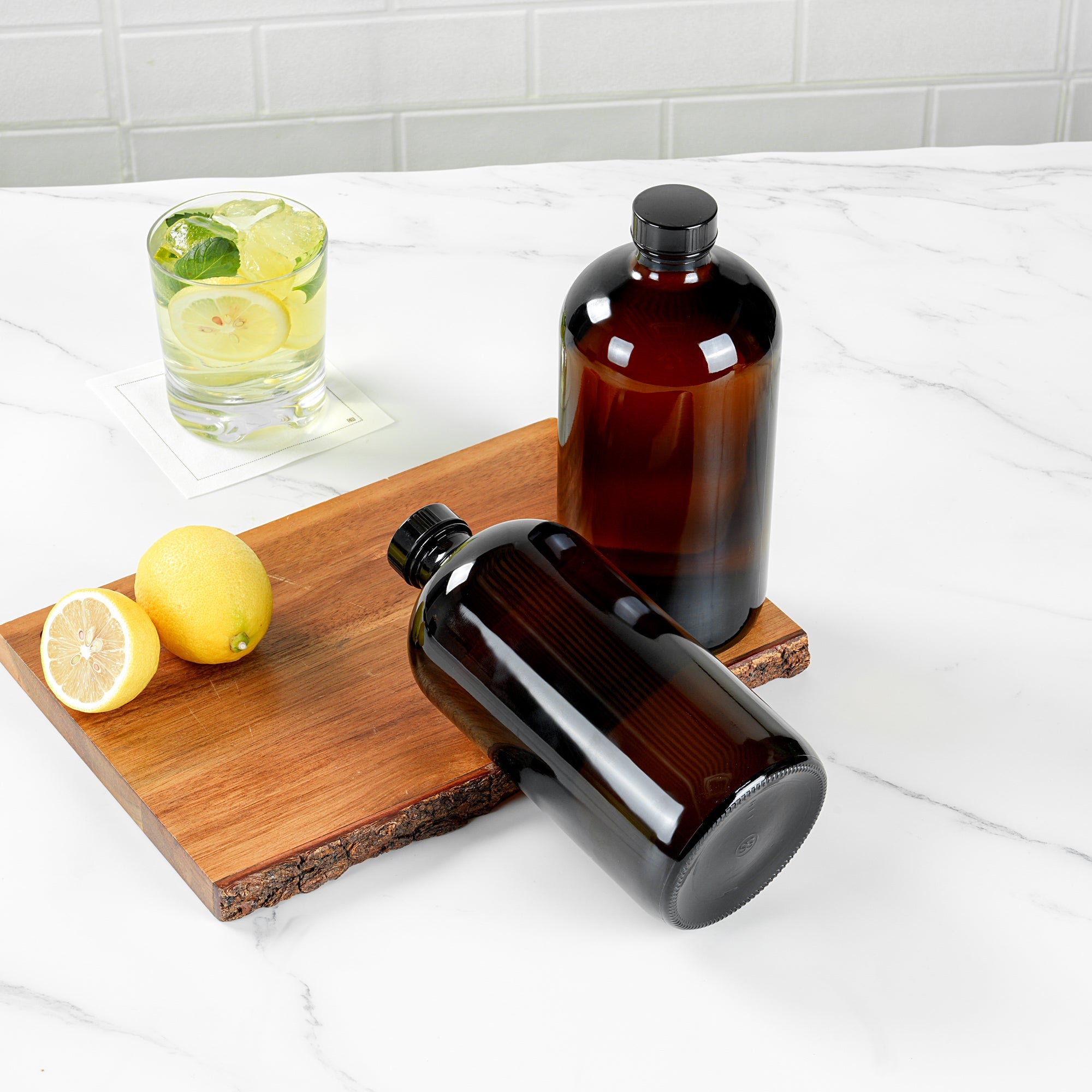 Vetri 32 oz Boston Round Amber Glass Bottle - with Black Phenolic Cap - 3 3/4" x 3 3/4" x 8" - 12 count box