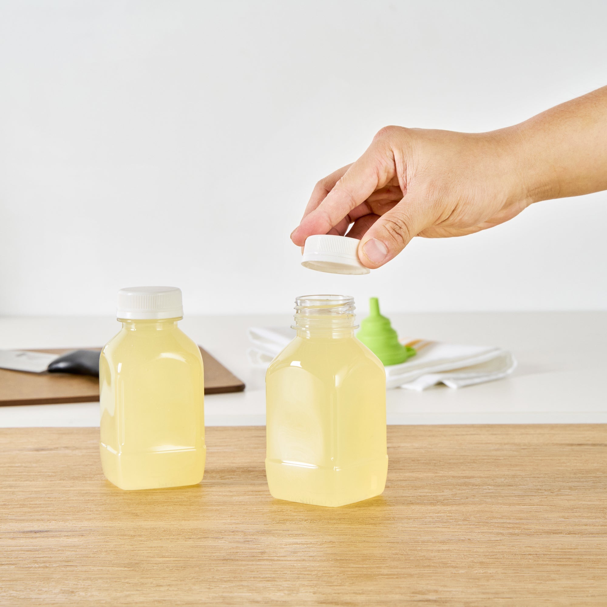Bottle Tek 8 oz Square Clear Plastic Cold Pressed Juice Bottle - with Safety Cap - 2 1/4" x 2 1/4" x 4 3/4" - 100 count box
