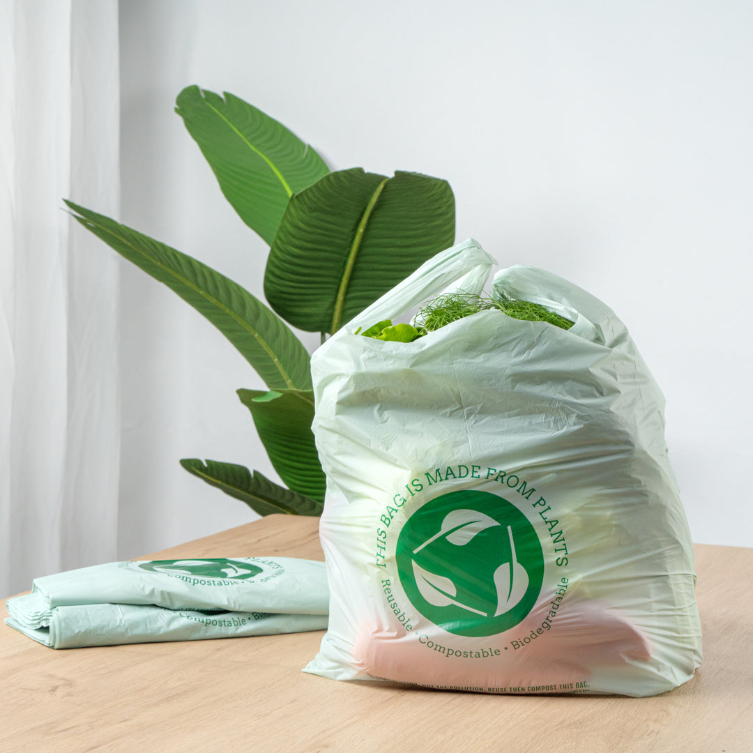 Basic Nature Green Plastic T-Shirt Bag - 1/6 Size, Compostable - 12" x 6 1/2" x 22" - 100 count box