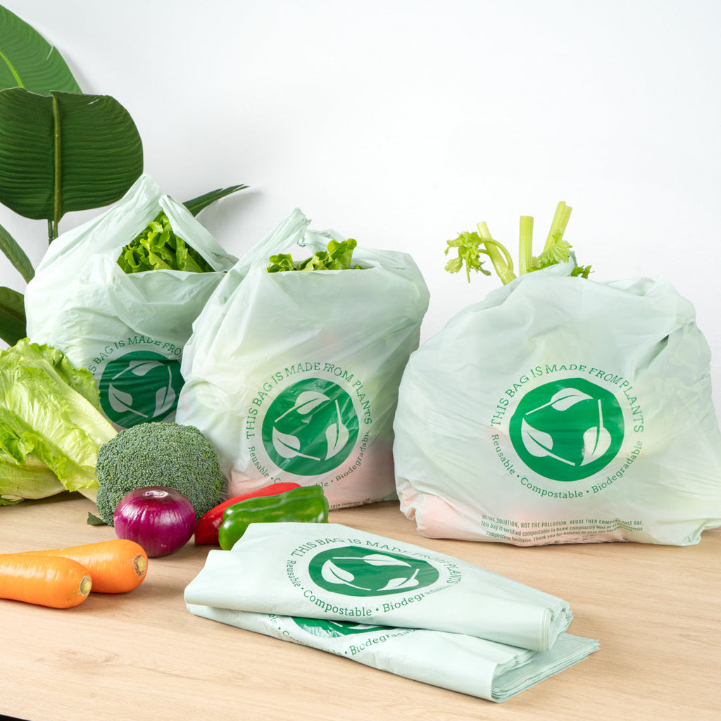 Basic Nature Green Plastic T-Shirt Bag - 1/6 Size, Compostable - 12" x 6 1/2" x 22" - 100 count box