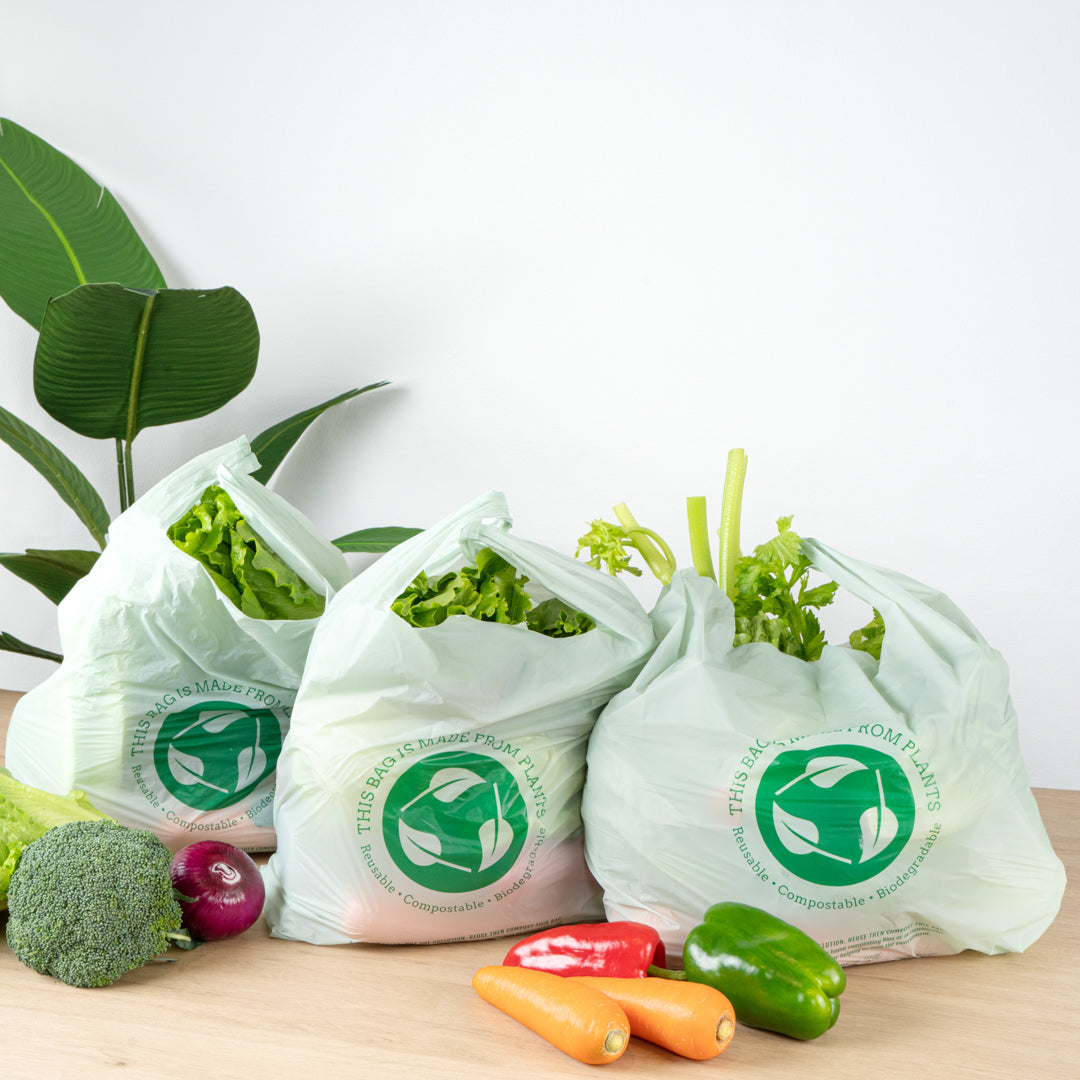 Basic Nature Green Plastic T-Shirt Bag - 1/6 Size, Compostable - 12" x 6 1/2" x 22" - 500 count box