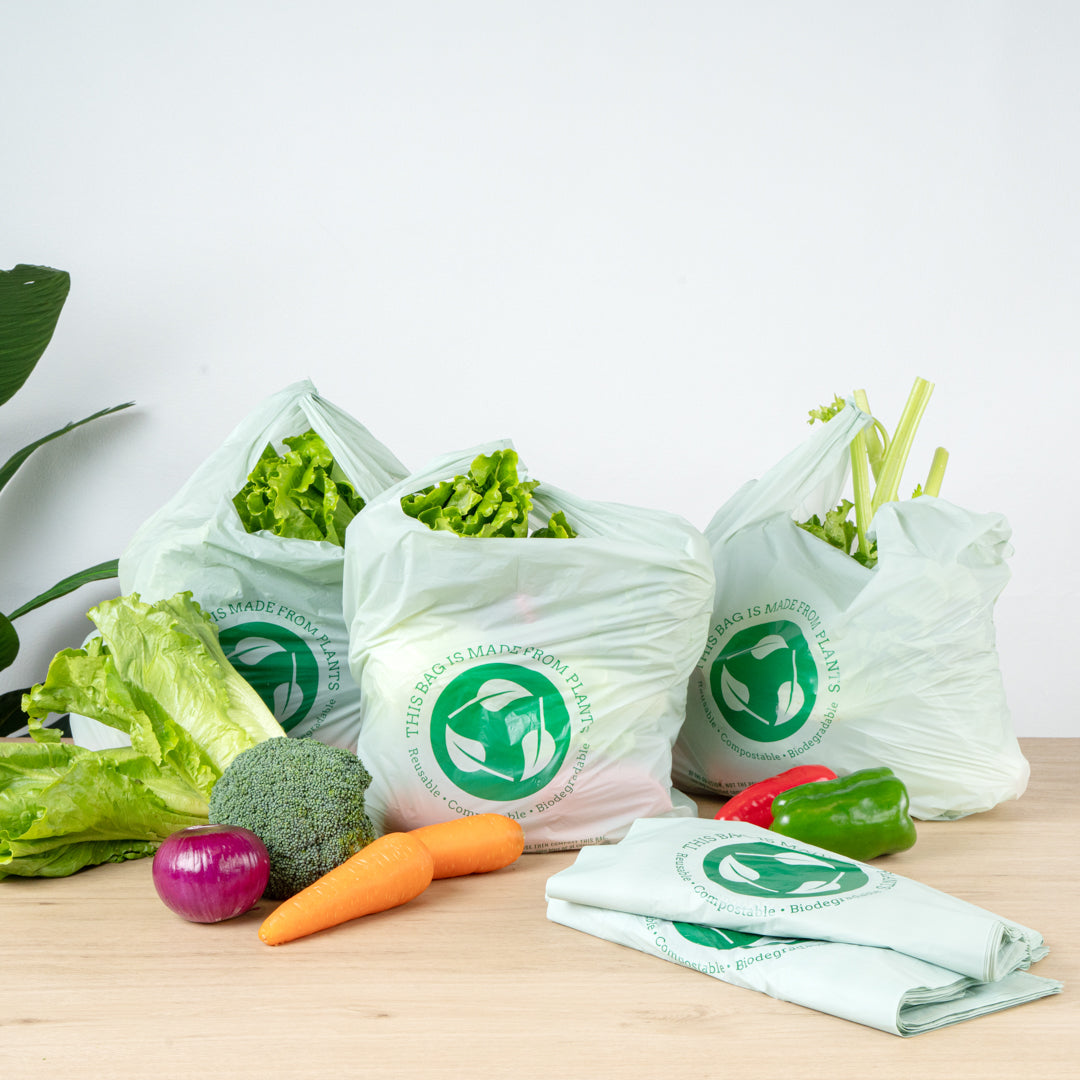 Basic Nature Green Plastic T-Shirt Bag - 1/6 Size, Compostable - 12" x 6 1/2" x 22" - 500 count box