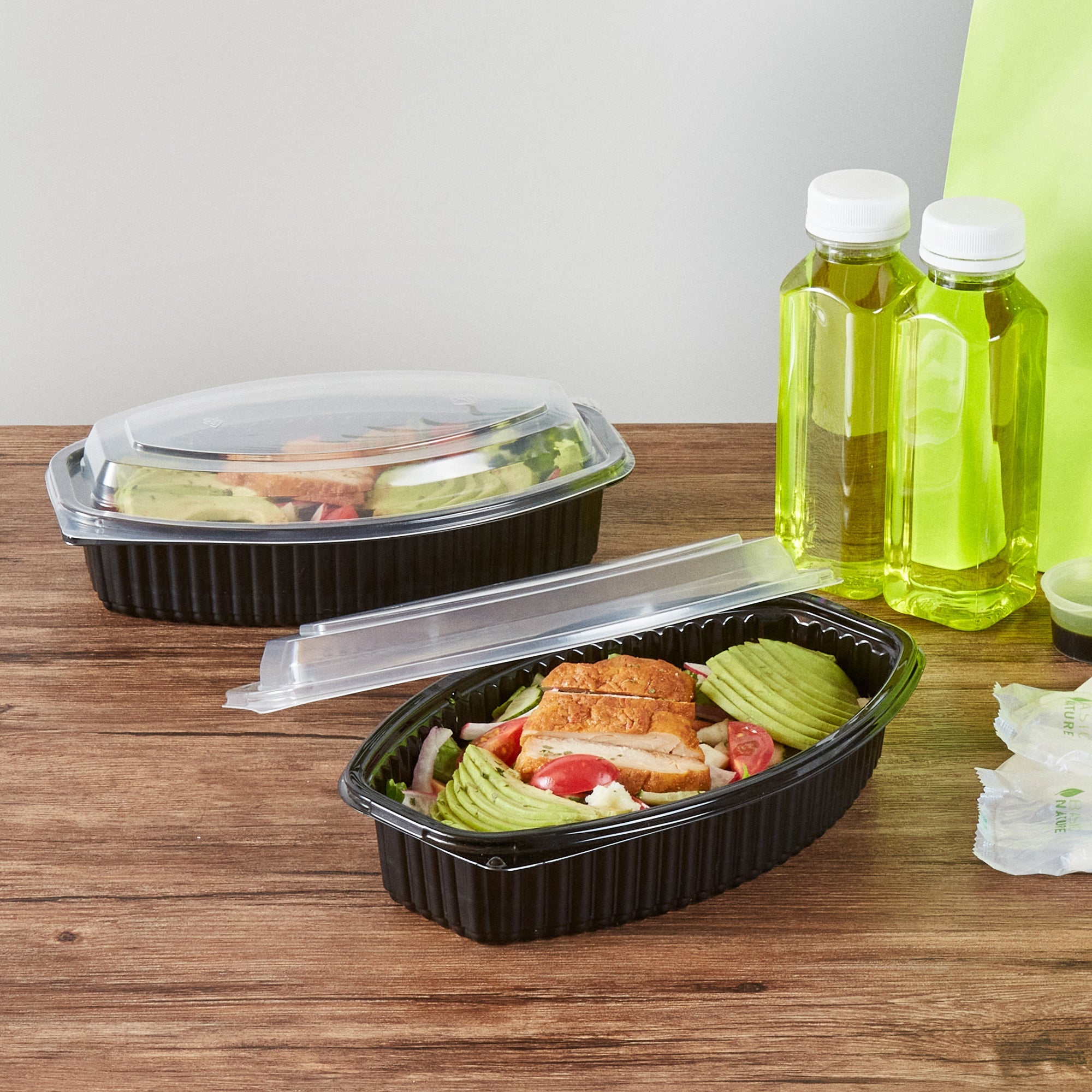 Chef 101 28 oz Oval Black Plastic Food Container - with Clear Lid, Microwavable - 9 1/4" x 5 3/4" x 2 3/4" - 50 count box