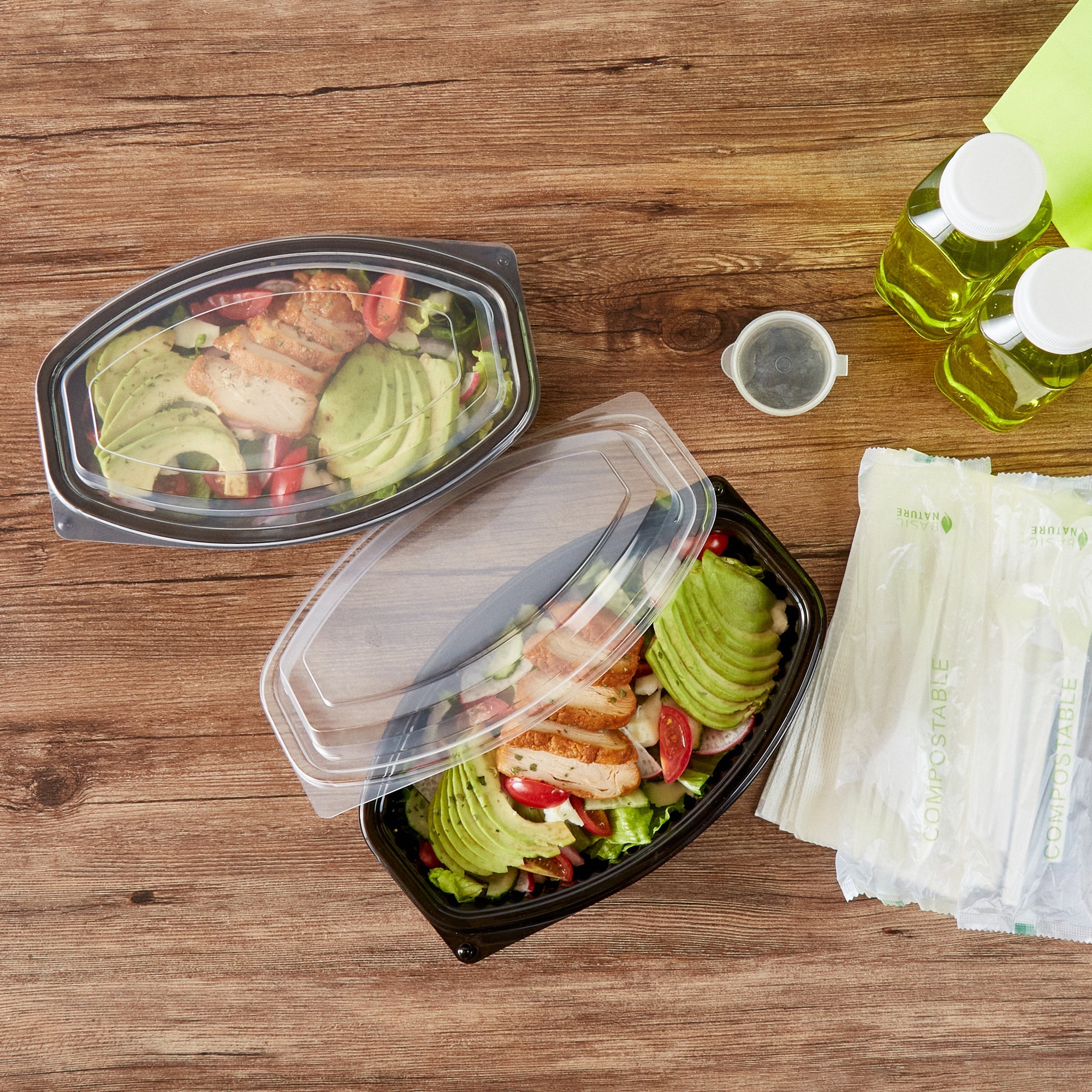 Chef 101 28 oz Oval Black Plastic Food Container - with Clear Lid, Microwavable - 9 1/4" x 5 3/4" x 2 3/4" - 50 count box