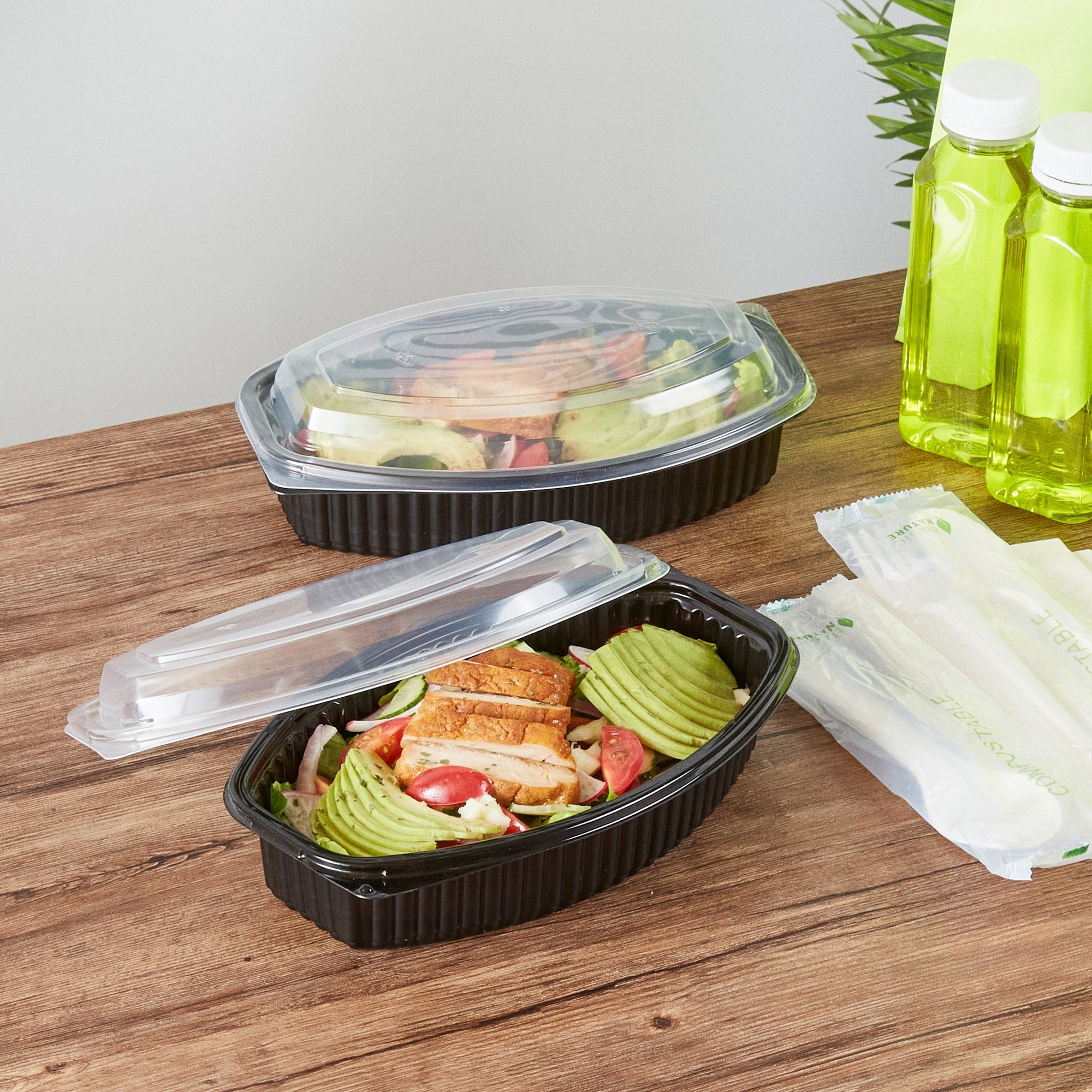Chef 101 28 oz Oval Black Plastic Food Container - with Clear Lid, Microwavable - 9 1/4" x 5 3/4" x 2 3/4" - 100 count box