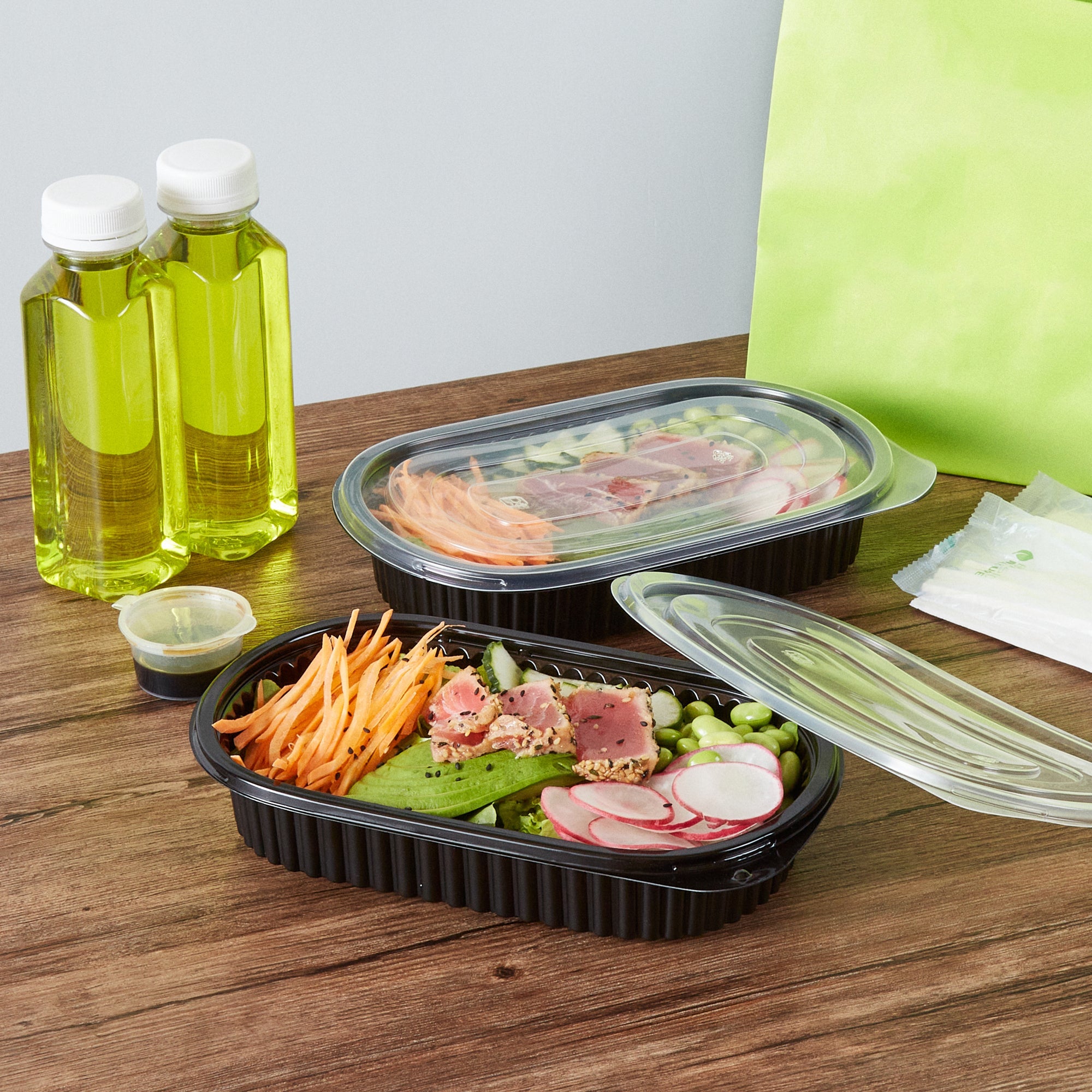 Chef 101 25 oz Oval Black Plastic Food Container - with Clear Flat Lid, Microwavable - 9 1/4" x 6" x 1 3/4" - 50 count box