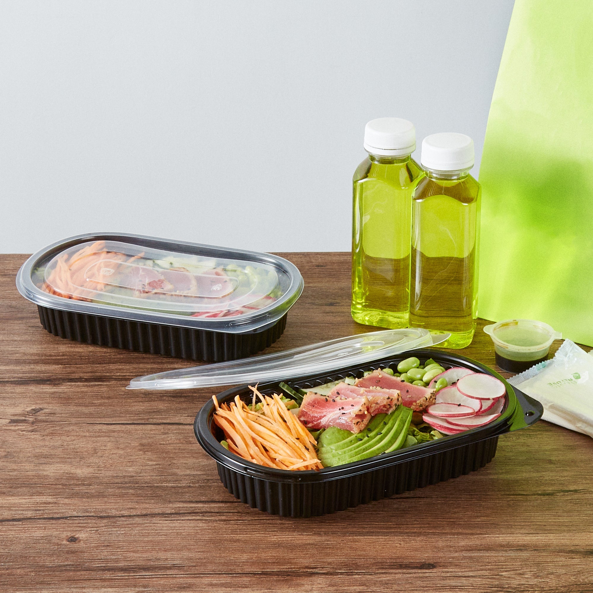 Chef 101 25 oz Oval Black Plastic Food Container - with Clear Flat Lid, Microwavable - 9 1/4" x 6" x 1 3/4" - 50 count box