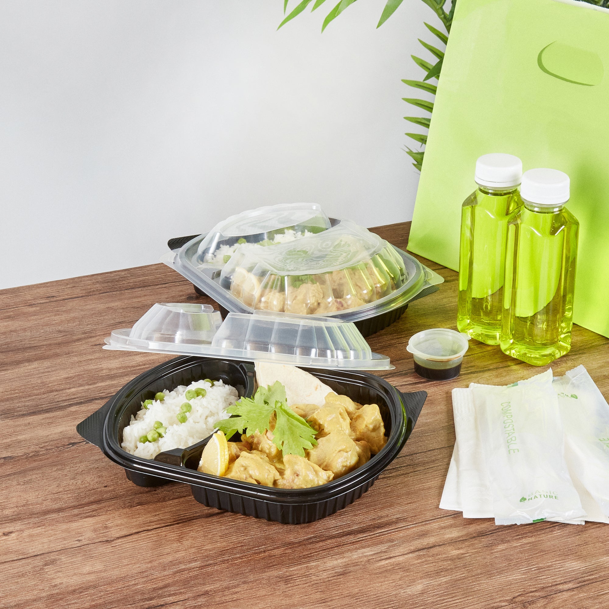 Chef 101 28 oz Oval Black Plastic Food Container - with Clear Lid, 2 Compartments, Microwavable - 9 1/2" x 8" x 2 3/4" - 100 count box