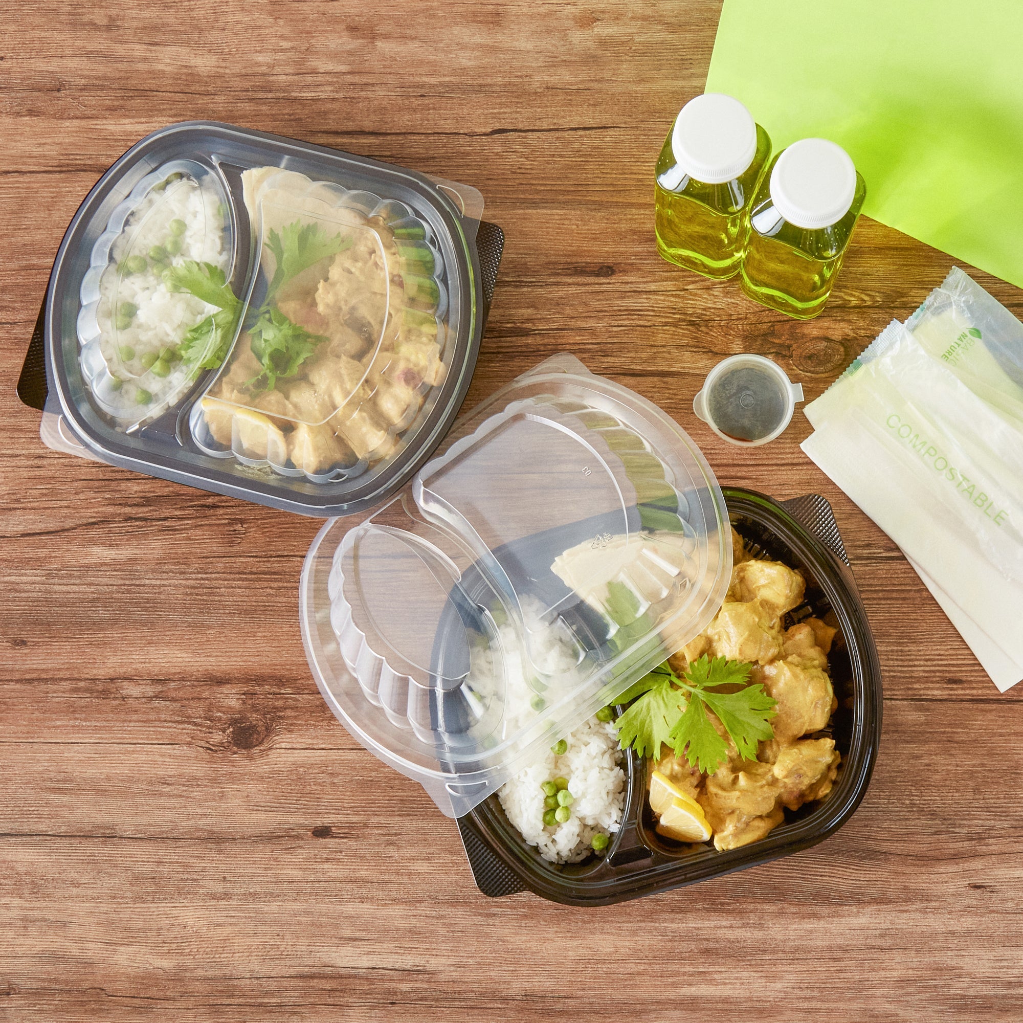 Chef 101 28 oz Oval Black Plastic Food Container - with Clear Lid, 2 Compartments, Microwavable - 9 1/2" x 8" x 2 3/4" - 100 count box