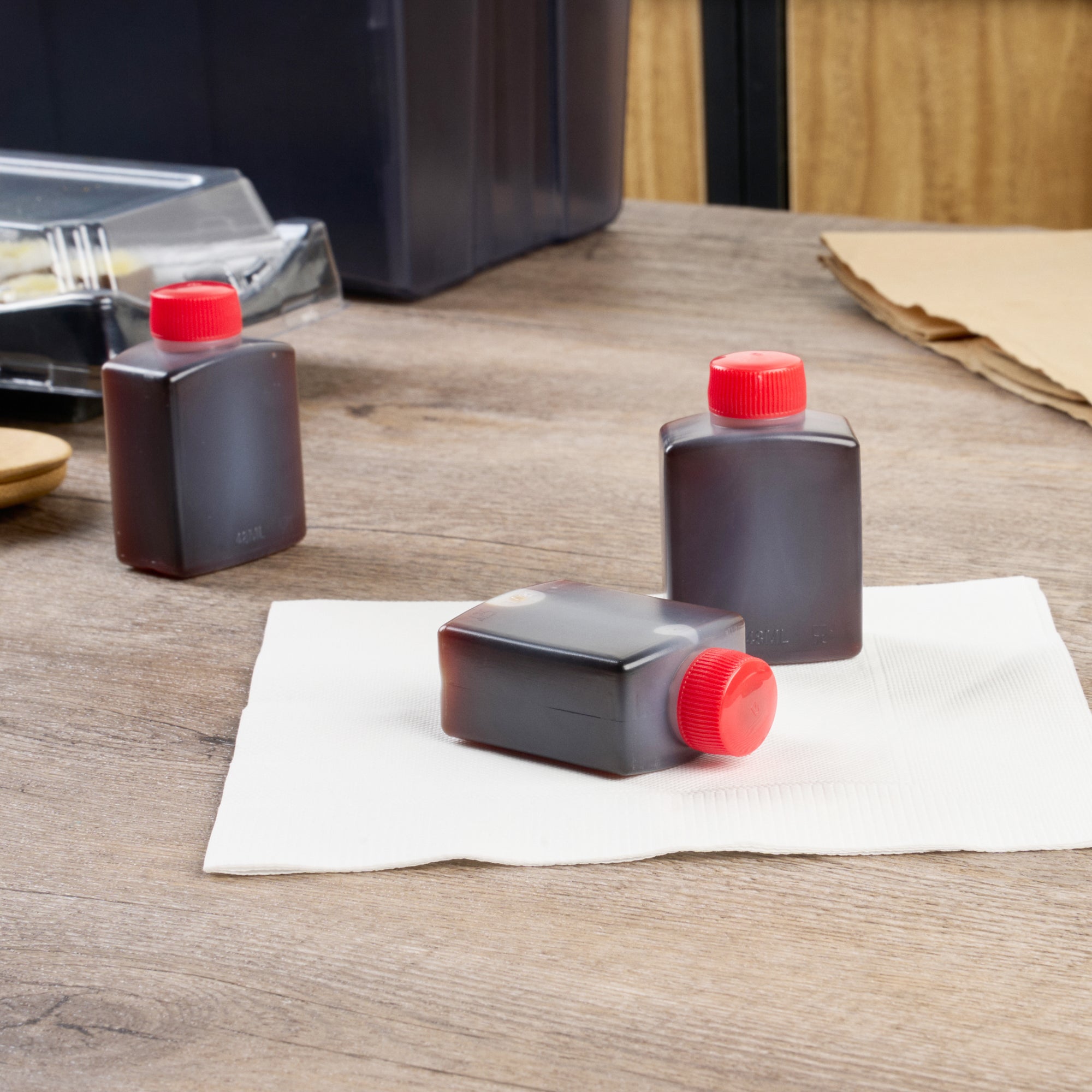 Bento Tek 2 oz Translucent Plastic Soy Sauce Bottle - with Red Cap - 1 1/2" x 1" x 2 1/2" - 100 count box