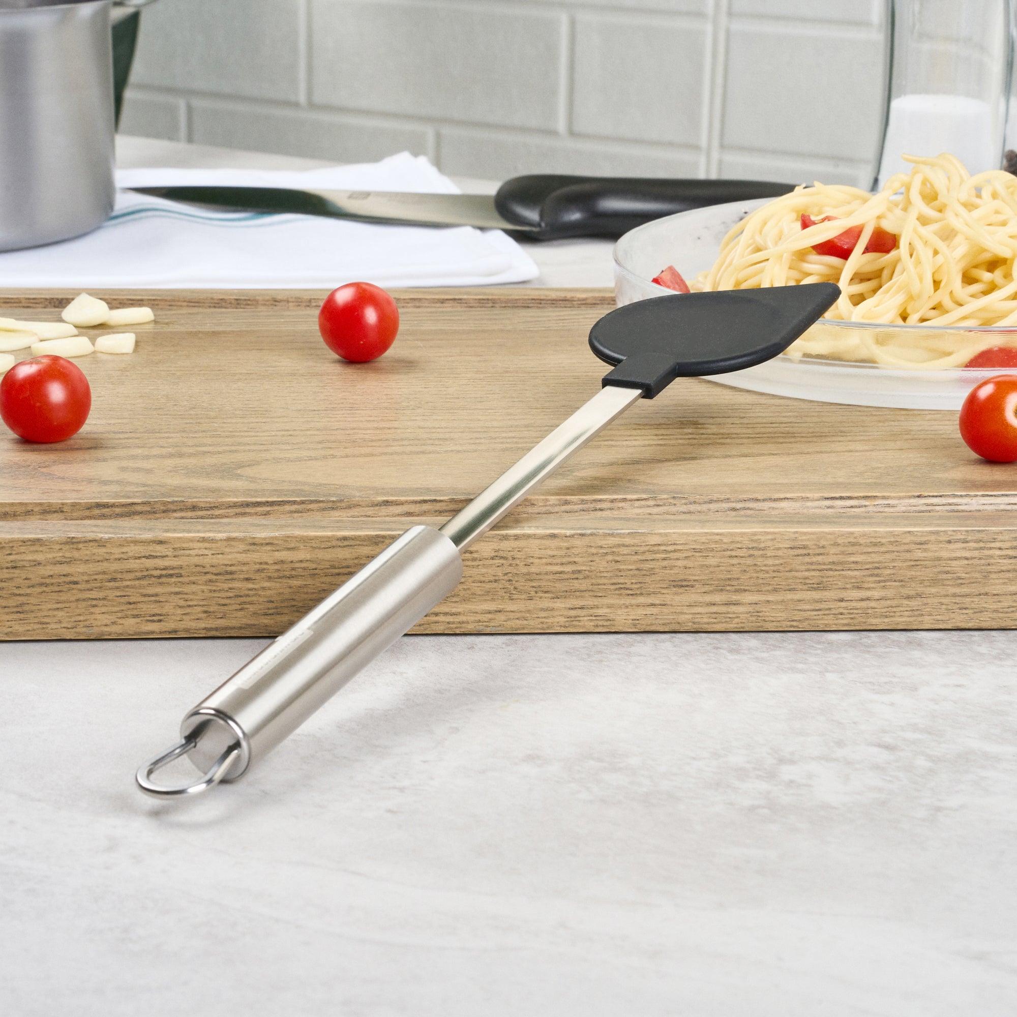 German Standard Black Nylon High Heat Cooking Spoon - Pointed Tip, with Stainless Steel Handle - 12 3/4'' x 2 1/4'' - 1 count box