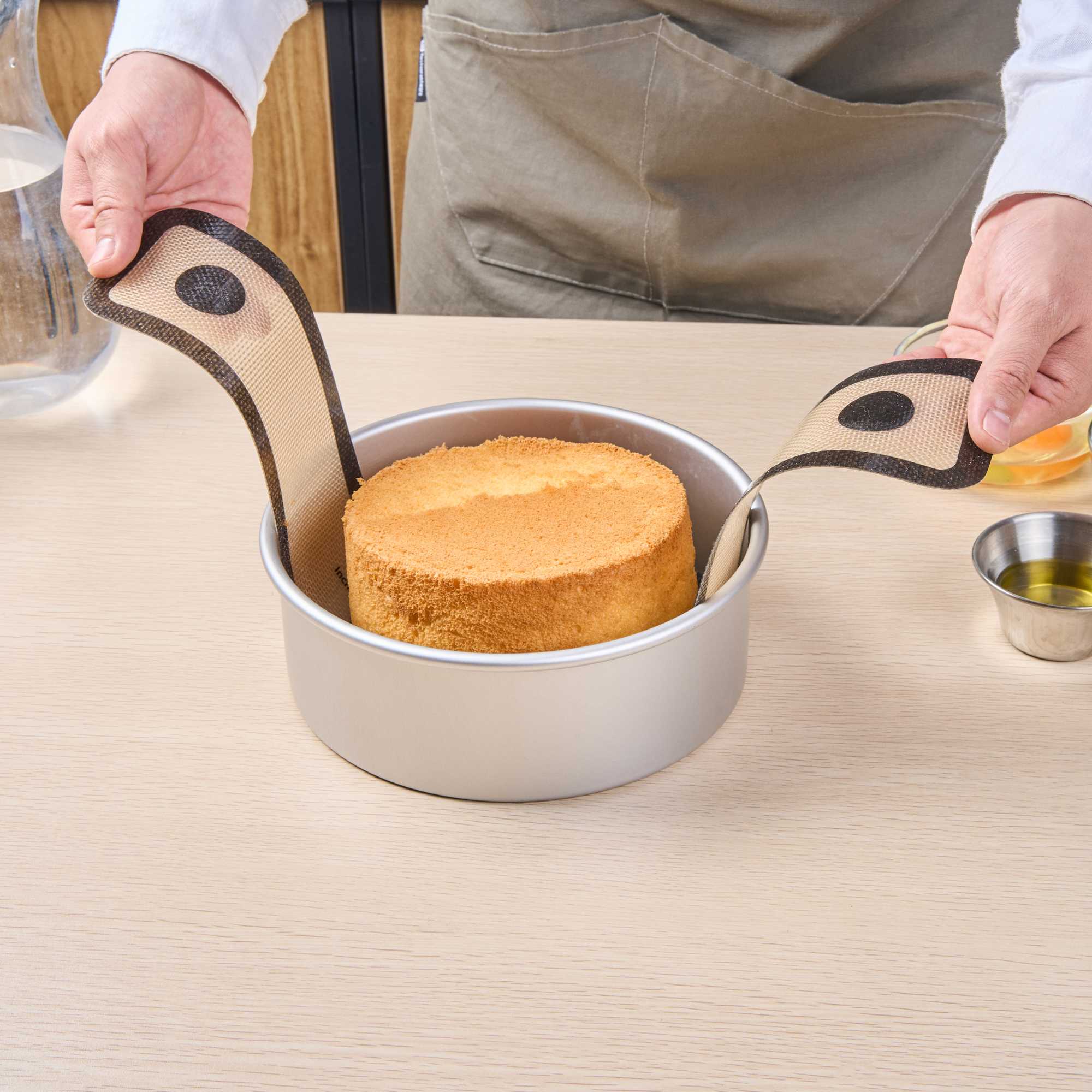 Pastry Tek Round Tan and Black Fiberglass Bread Sling - For Dutch Oven, with Long Handles - 22 3/4" x 8 1/4" - 1 count box