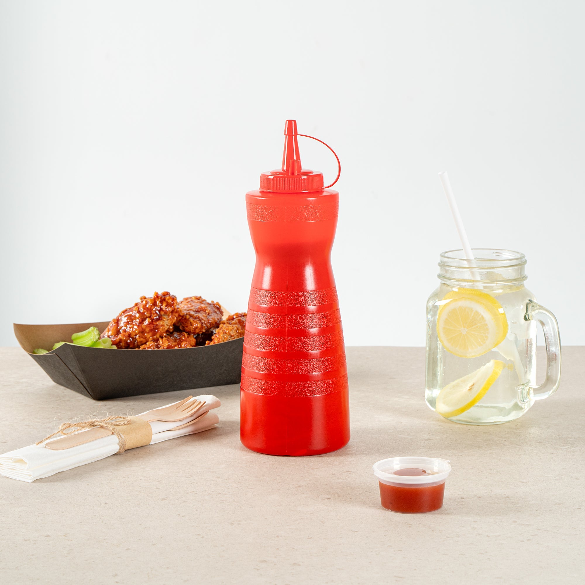 Sauce Tek 24 oz Red Plastic Squeeze Bottle - with Cap - 2 3/4" x 2 3/4" x 10 1/4" - 1 count box
